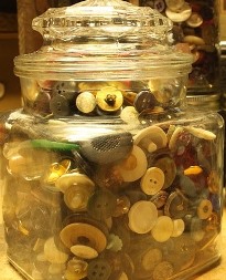 A large glass jar full of buttons, from our "God Cares for You" Bible lessons for kids