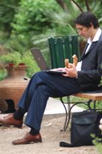 man sitting on park bench eating his lunch